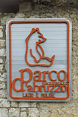 Sign of the Abruzzo National Park with its emblem, the Marsican brown bear (Ursus arctos marsicanus), Italy