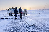 Extraction of ice cube from the Lena river for use as drinking water by residents without access to running water, Yakutsk, Republic of Sakha, Russia