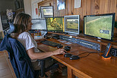 Erika Diaz Hernandez, part of the team of surveillance, controls the monitors installed in the enclosures and collects data. Centro de Cría del Lince Ibérico El Acebuche, Donana National Park, Andalusia, Spain.