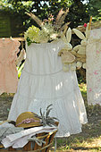 Hanging laundry in the garden, flowers, children's clothes and stuffed rabbits. Lavender flowers and straw hat, garden atmosphere