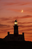 L’AGULHAS, WESTERN CAPE, SOUTH AFRICA - AUGUST 23, 2022 - Evening view of Cape Agulhas Lighthouse, located at the southernmost point of Africa and lies at 20 degrees east. Popular tourist destination.