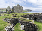 Jarlshof, an archaeological site on the Shetland Islands, which was inhabited from neolithic times to the middle ages.Wheelhouses dating back to the Iron Age, background is the Old House from the middle ages and the lightouse of Sumburgh Head. Europe, Great Britain, Scotland, Northern Isles, Shetland, May
