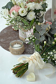 Table bouquet, Rose (Rosa sp), Gypsophila (Gypsophila paniculata), romantic atmosphere, heart-shaped candle and ribbon bow