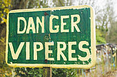 'Danger vipers' sign at the edge of a small stream and allotments, Allier, Auvergne, France