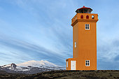 Svörtuloft Lighthouse, view of the lighthouse with a snow-capped mountain in the background, Western Region, Iceland