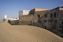 Morocco, Essaouira, 2022-11-14. Sand dune piling up outside building near the beach of Essaouira. Housing are experiencing silting that has intensified as a result of one of the effects of climate change, the intensification of strong winds carrying sand from the dunes north of the city.