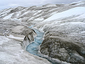Drainage system on the surface of the ice sheet. The brown sediment on the ice is created by the rapid melting of the ice. Landscape of the Greenland ice sheet near Kangerlussuaq. America, North America, Greenland, danish territory
