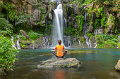 Woman at the edge of Bassin des Aigrettes, Saint Gilles, Reunion Island, France