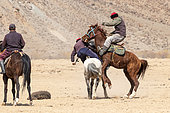 Riders at a game of Kok-boru (or Ulak-tartish or Buzkachi), Central Asian equestrian games at the Noorus festival, Kotchkor, Naryn Region, Kyrgyzstan