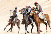 Riders at a game of Kok-boru (or Ulak-tartish or Buzkachi), Central Asian equestrian games at the Noorus festival, Kotchkor, Naryn Region, Kyrgyzstan
