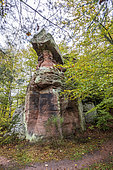 Pink sandstone cliff in the forest in autumn, Moselle, France