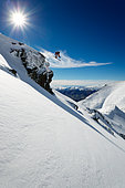 Skier jumping a rock, South Island, New Zealand