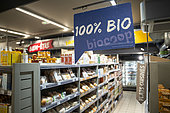 100% organic sign in the aisle of a Biocoop supermarket, Lyon, France.