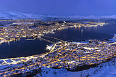 View of the city of Tromso plunged into the polar night from the Fjellstua lookout, Norway, Arctic