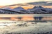 Landscape amidst fjiords and sharp Alpine mountains, the sun is not visible in winter, only the moon illuminates the landscape Islands around Tromso in Norway