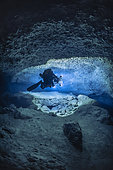 Tek rebreather diver at a depth of 70 meters with a DPV specially equipped with 60,000 lumen lighting and 12 Gopro to carry out a 3D survey of a karstic cave submerged for over 14,000 years, Passe Bateau Sud, Mayotte Lagoon