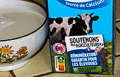 A one-liter milk carton reads "Support our farmers, guaranteed remuneration for breeders", Le Mans, Sarthe, France