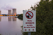 Cattenom nuclear power plant in Moselle, France, with four reactors in operation at sunset and an artificial lake serving as a cooling pond. France