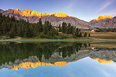 Lac des prés Soubeyrand or lac Miroir (2214 m), the sun illuminates the Crête des Veyrés (3000 m), and on the right the Pointe de la Saume (3043 m), Ceillac, Queyras Regional Natural Park, Hautes Alpes, France