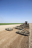 Farmers using tool trains to prepare the soil in one pass just before sowing on light loamy, chalky soil in the Brie region, Marne, France.