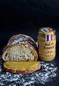 Honey jar from France from the Michaud family, beekeepers since 1920, Bread covered with flour and slice of bread covered with Honey. Packaged in glass jars in the Pyrenees, France