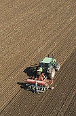 Aerial view of cereal or rapeseed sowing with a conventional seed drill combined with a rotary harrow, Farmer controlling the seed drill, France