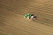 Aerial view of the accor pneumatic combination seeder (four-meter wide) sowing protein or oilseed crops on finely prepared soil. France