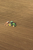 Aerial view of the accor pneumatic combination seeder (four-meter wide) sowing protein or oilseed crops on finely prepared soil. France