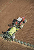 Aerial view of spraying, treatment on bare soil. Pre-sowing, post-sowing or pre-emergence weed control for maize, rapeseed, wheat or barley, France