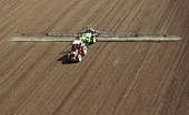 Aerial view of spraying, treatment on bare soil. Pre-sowing, post-sowing or pre-emergence weed control for maize, rapeseed, wheat or barley, France