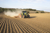 Sowing rapeseed, barley or wheat with a Vederstad seed drill pulled by a claas tractor in the middle of a drought.