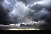 Stormy skies over the countryside at sunset in late summer, France