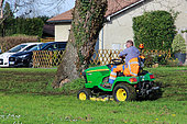 Municipal green space maintenance worker mowing a lawn, Sarthe, France