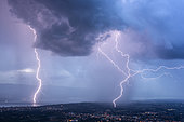 Thunderstorm and lightning near Annemasse and on Lake Geneva. Two lightning strikes on Lake Geneva and near Annemasse during a very electric storm at the blue hour. Haute-Savoie, Alps, France