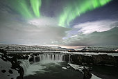 Aurora borealis above Goðafoss waterfall, Iceland.
