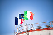 French, Italian and European flags flying from the roof of one of Concordia's two towers. Concordia is a Franco-Italian station, financed equally by the two countries. The flags are removed for the winter period, as the cold would loosen the fabric. Concordia Antarctic Scientific Research Station, Dome C plateau, East Antarctica.
