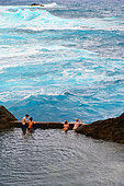 Bathers in the natural pools by the sea. Porto Moniz. Madeira island. Portugal.
