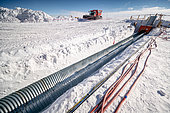 The technical tunnel trench, with cables ready for installation. The metal technical tunnel is designed to carry the electrical cables supplying the station's main scientific areas. Concordia Antarctic Research Station, Dome C plateau, East Antarctica.