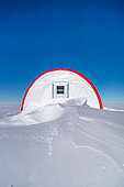 A dormitory tent, around which snow has accumulated over the past year. Little Dome C, Antarctic Plateau, Antarctica