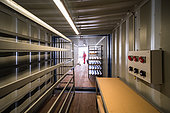 The inside of a tunnel made up of 3 containers placed end-to-end at the bottom of a long, 4-meter-deep trench. The containers are then covered with around 2 meters of snow to keep them at the lowest possible temperature. They are used for temporary storage of ice cores. Little Dome C, Antarctic Plateau, Antarctica