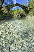 Ancient bridge overlooking the crystal-clear waters of the Rio Vero in Sierra de Guara. Natural park renowned for climbing and canyoning in the province of Huesca in Aragon, Spain.