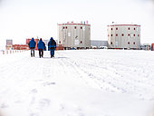 Three scientists walk back to the station. Concordia Antarctic Research Station, Dome C plateau, East Antarctica.