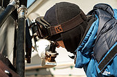 Karim Agabi checks that his telescope is in focus. Concordia Antarctic Research Station, Dome C plateau, East Antarctica.