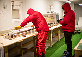 Two scientists cut and pack ice cores. They work for the German polar institute, AWI. Concordia Antarctic Research Station, Dome C plateau, East Antarctica.