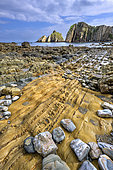 The famous Playa del Silencio on Spain's Asturias coast. Low tide reveals the remarkable polychrome strata of quartzite, sandstone and shale, deformed by tectonics and dating from the Paleozoic (Cambrian/Ordovician) - Asturias - Spain