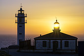 Lighthouse at dusk on the Costa da Morte in Galicia, Spain. Cape Touriñan lighthouse at the extreme tip of Galicia, constantly battered by storms and often in fog.