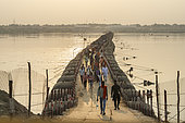 Kumbh Mela 2025: The Sacred Goes Viral. Pilgrims on the Floating Bridges of the Kumbh Mela. Crossing the Sacred Waters. As millions of pilgrims arrive at the Maha Kumbh Mela, the floating bridges serve as vital passages over the holy Ganges River. Walking across these makeshift structures, pilgrims are not just crossing water, they are crossing into a deeper spiritual realm. The path is lined with devotion, as each step brings them closer to purification and peace. These bridges, built to withstand the immense flow of people, represent both the physical and spiritual journeys that define the Kumbh Mela, where faith and resilience merge on the sacred waters.