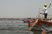 Kumbh Mela 2025: The Sacred Goes Viral. The Boatman Amidst the Vastness of the Kumbh Mela. A Boatman with the Grandeur of the Kumbh Mela in the Background. A boatman navigates his small boat through the sacred waters of the Ganges, with a line of other boats following closely behind. The boatman, a humble figure amidst the sea of boats, plays a crucial role in transporting pilgrims to the holy Sangam for their sacred dip. Behind him, the vastness of the Kumbh Mela unfolds, with thousands of tents, boats, and devotees stretching across the horizon. This powerful image captures the scale of the festival, where individual efforts contribute to the collective spiritual journey. The boatman, though small in the grand scene, embodies the spirit of service, navigating not only the waters but also the massive pilgrimage that has gathered in faith.