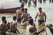 Kumbh Mela 2025: The Sacred Goes Viral. A Sacred Moment Captured. Pilgrims Immortalizing Their Sacred Bath with a Smartphone. In the holy waters of the Ganges, a group of pilgrims stands together, ready to immerse themselves in the sacred bath at the Kumbh Mela. As they prepare for the purification ritual, one of the group members captures the moment with their smartphone, immortalizing the experience for social media or personal remembrance. This scene beautifully blends devotion with the modern world, as the sacred and the digital coexist. The pilgrims, united by their faith, share not only the spiritual significance of the bath but also the desire to preserve the memory of this moment in the digital age, highlighting how ancient rituals and contemporary technology harmonize at the Kumbh Mela.