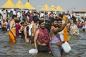 Kumbh Mela 2025: The Sacred Goes Viral. Capturing the Sacred Moment. Pilgrims Taking a Selfie During the Sacred Bath. A group of pilgrims, united by their faith, take a moment to capture a selfie during the sacred bath at the Kumbh Mela. With the holy waters of the Ganges flowing around them, they smile and pose for the camera, immortalizing the experience on their smartphones. This image beautifully juxtaposes the timeless spiritual significance of the bath with the contemporary desire to document the moment. The scene highlights how the younger generation engages with ancient traditions through the lens of modern technology, while still embracing the deeply rooted rituals that have defined the Kumbh Mela for centuries. The selfie becomes a bridge between personal memories and the collective spiritual journey of millions.